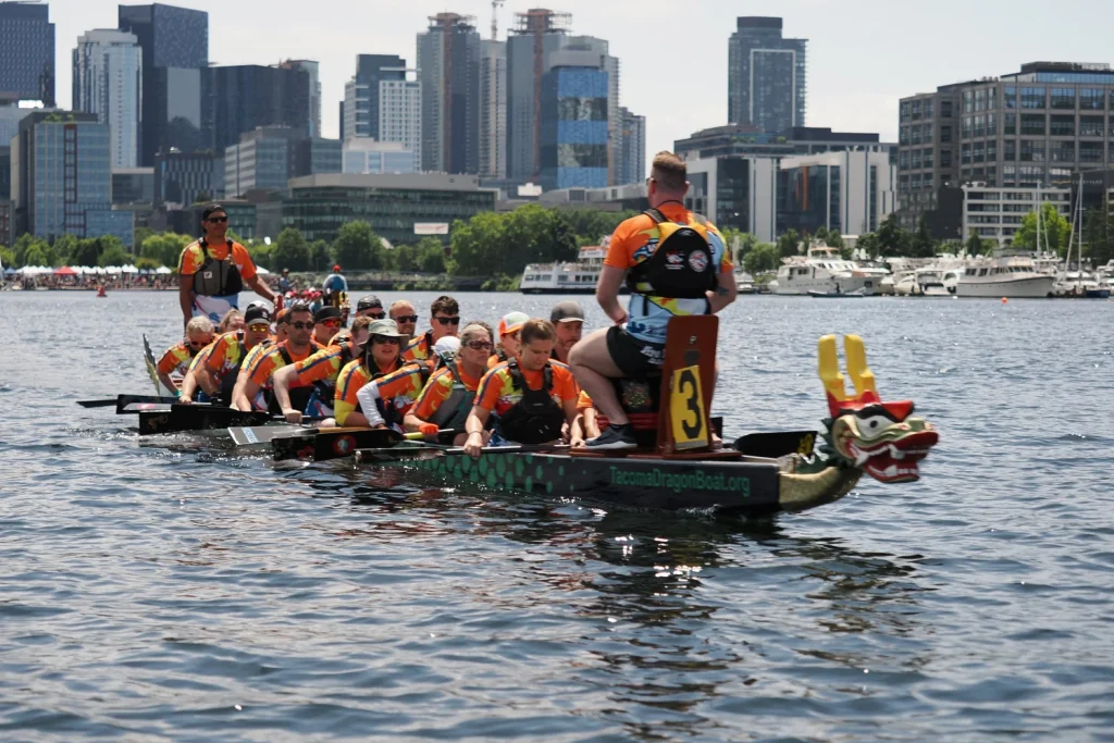Boat racing under a city skyline